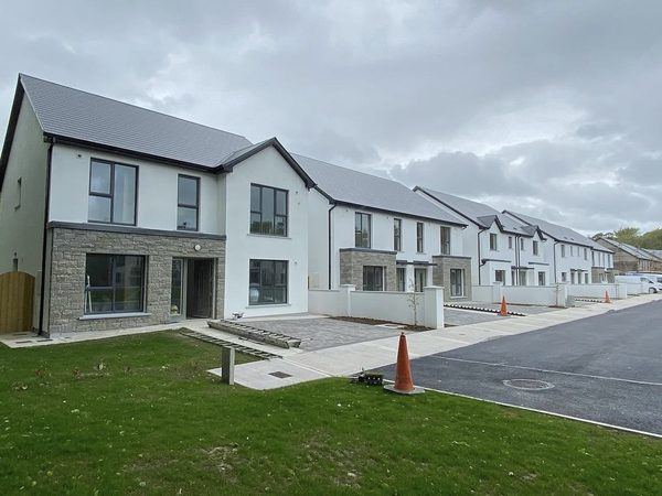 Street of homes with stone facing at Barters Wood, Blarney