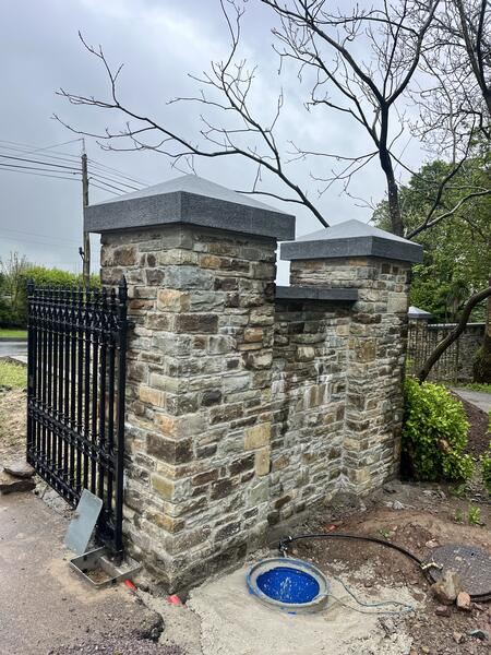 Stone entrance pillars with granite caps