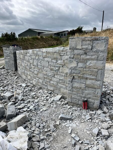 Dry stone wall with square pillars