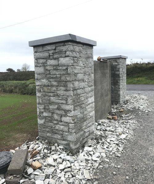 Stone entrance piers with slate caps