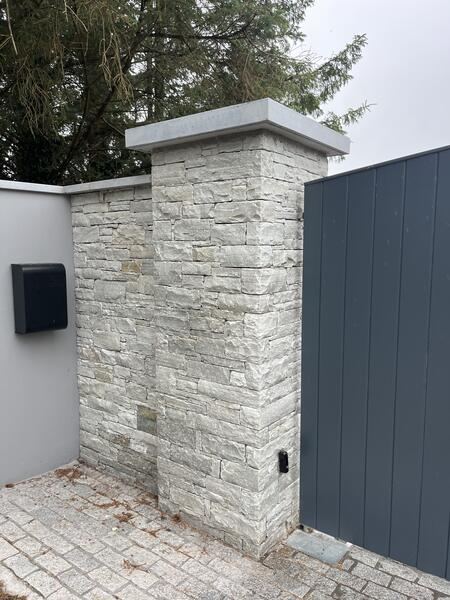 Stone gate pillar with granite capping