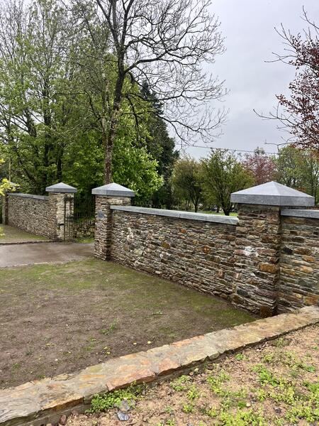 Stone entrance wall with gates