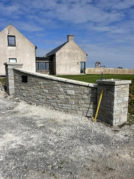 Stone boundary wall to modern home