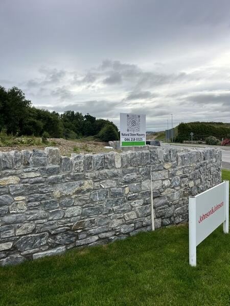M28 Motorway stone wall with Natural Stone Masonry signage