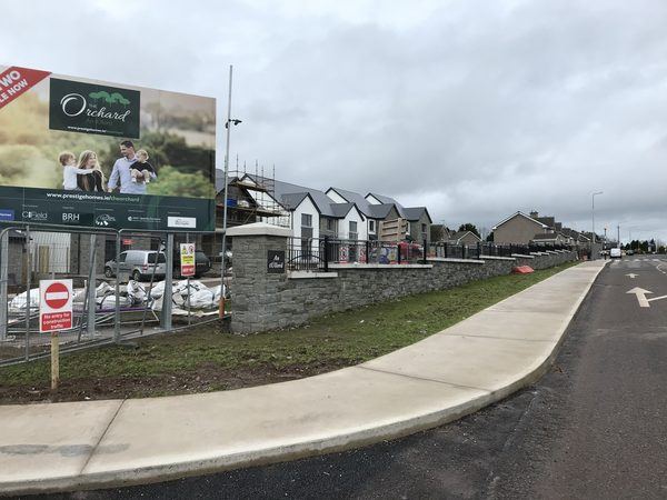 Stone boundary wall and estate signage at The Orchard