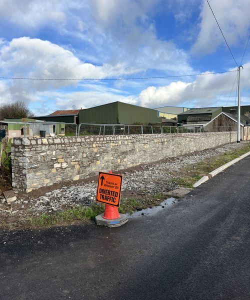 Limestone boundary wall along public road