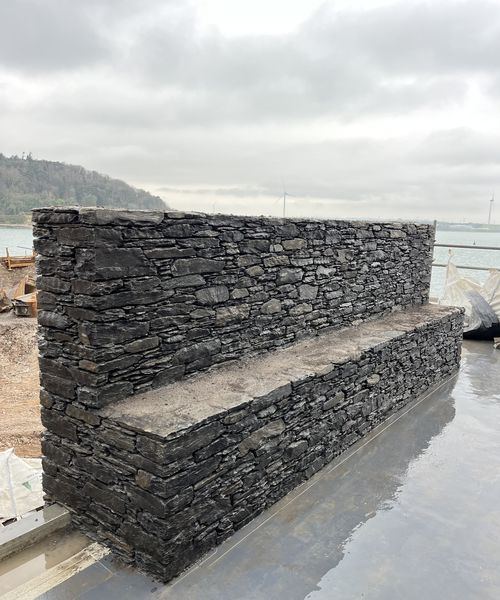Stepped dry stone slate wall at waterfront site