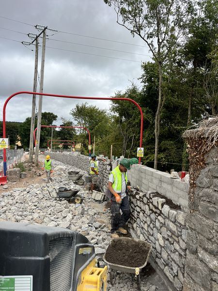 Stonemasons building roadside stone facing at Water Rock, Midleton