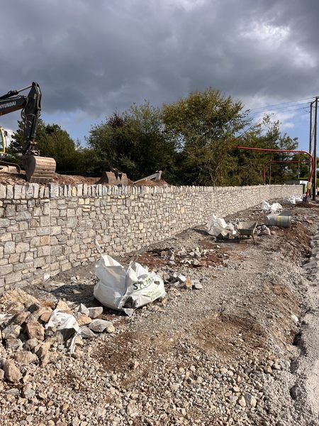 Stone faced retaining wall with castellated coping nearing completion on the Water Rock Road scheme, Midleton, Co. Cork